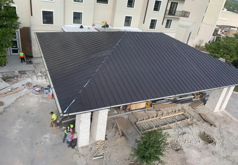 Metal roofing installation team working on a commercial building in Pittston